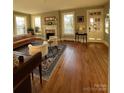 Bright living room features hardwood floors, a decorative fireplace, and multiple windows for natural light at 324 N 5Th St, Albemarle, NC 28001