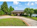 Charming single-story home with a circular driveway and well-maintained landscaping at 42 Linford St, Belmont, NC 28012