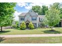 Beautiful two-story home with lush landscaping, featuring a well-maintained lawn and mature trees at 4225 Abernathy Pl, Harrisburg, NC 28075