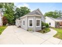 Charming gray home with a well-kept lawn, adjacent driveway, and a neighbor's home nearby at 509 W Sixth Ave, Gastonia, NC 28052