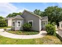 Charming gray home featuring a bay window and manicured front garden at 509 W Sixth Ave, Gastonia, NC 28052