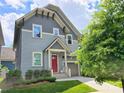 Attractive two-story home with gray siding, bright red door, a well-kept lawn and a welcoming driveway at 5210 Kelly St, Charlotte, NC 28205