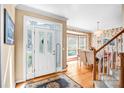Bright foyer featuring a decorative front door, wood flooring, and a glimpse of the dining area at 5238 Downing Creek Dr, Charlotte, NC 28269