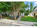 View of the home's front exterior showcasing well-maintained landscaping and a cozy front entrance with a small seating area at 541 River Park Rd, Belmont, NC 28012