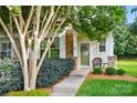 A welcoming home exterior featuring a stone facade accent, inviting front door with wreath, and manicured landscaping at 541 River Park Rd, Belmont, NC 28012