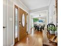 Bright foyer showcases hardwood floors and a view into the adjacent dining room at 5716 Trimmings Ct, Charlotte, NC 28226