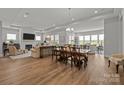 Open concept living space with fireplace, dining area, and hardwood floors providing ample room for entertaining at 7010 Brush Crk, Monroe, NC 28110