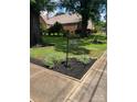 Landscaped yard with an elegant sign post displaying the property's address at 80 Pine St, Badin, NC 28097