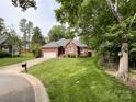 Beautifully landscaped brick home with a well-kept lawn and mature trees at 8105 Rachel Ct, Waxhaw, NC 28173