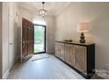 Inviting foyer with hardwood floors, stylish console table, and decorative lighting at 8105 Rachel Ct, Waxhaw, NC 28173
