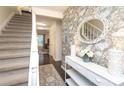 Welcoming foyer with floral wallpaper, mirror, and console table at 8306 Knights Bridge Rd, Charlotte, NC 28210