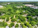 Birds-eye view displaying a large residential area with lush green trees and scattered homes at 84 Sumner Nw Ave, Concord, NC 28027