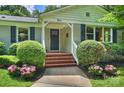 Inviting front entrance with brick steps, manicured bushes, and beautiful pink flowers at 901 Scaleybark Rd, Charlotte, NC 28209