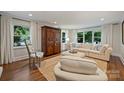 Bright living room with hardwood floors, large windows, and elegant decor at 901 Scaleybark Rd, Charlotte, NC 28209