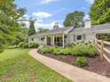 Inviting brick home with a covered porch, manicured landscaping, and a charming walkway at 1031 Eldorado Ave, Charlotte, NC 28262