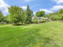 Expansive lush green lawn and mature trees surrounding a bright and beautiful home at 1031 Eldorado Ave, Charlotte, NC 28262