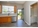 Well-lit kitchen featuring modern appliances, laminate flooring and a convenient half bathroom at 105 Woodsong Ln, Mooresville, NC 28117