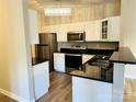 Well-lit kitchen with white cabinetry, stainless steel appliances, and modern finishes at 10673 Hill Point Ct, Charlotte, NC 28262