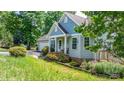 Scenic view of a well-maintained home with lush landscaping, offering a serene and private outdoor space at 109 Gatwick Ct, Statesville, NC 28677