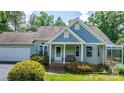 Inviting front porch with a cozy bench, brick steps, and well-maintained landscaping creates a welcoming entrance at 109 Gatwick Ct, Statesville, NC 28677