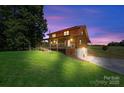 Back view of home with long porch and ramp leading down to the driveway at 11227 Cool Springs Rd, Cleveland, NC 27013