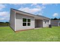 Spacious backyard featuring a covered patio and green grass, ideal for outdoor activities and relaxation at 1510 Doran Ter, Richburg, SC 29729