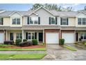 Charming townhouse with brick facade, garage, and well-maintained landscaping creates an inviting curb appeal at 15554 Stronvar House Ln, Charlotte, NC 28277