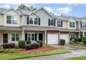 Townhouse exterior showcasing attached garage, landscaping, and neat curb appeal at 15554 Stronvar House Ln, Charlotte, NC 28277
