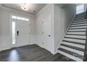 Bright and airy entryway with hardwood floors, staircase, and front door with sidelight at 16042 River Tree Ln, Charlotte, NC 28278