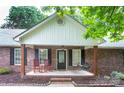 Inviting front porch with rocking chairs and porch swing, perfect for enjoying the outdoors at 1610 Ford St, Charlotte, NC 28216