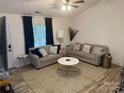 Well-lit living room with neutral tones, featuring two couches and modern geometric-patterned rug at 1623 Flagler Ln, Charlotte, NC 28216