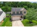 An aerial view of a well-kept two-story house with a front lawn and tree-lined backyard at 16615 Crimson Sargent Dr, Charlotte, NC 28213
