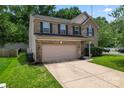 A two-story home with a two-car garage, complemented by a green lawn and tree backdrop at 16615 Crimson Sargent Dr, Charlotte, NC 28213