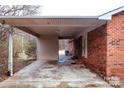 A brick house with a sheltered patio and a view of the outdoor surroundings at 1708 Dogwood Ln, Lancaster, SC 29720