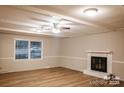 Living room featuring a fireplace, ceiling fan, and luxury vinyl plank flooring at 1708 Dogwood Ln, Lancaster, SC 29720