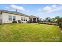 Large, well-maintained backyard with lush green grass and a black metal fence at 1825 Lotus Ln, Denver, NC 28037