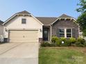 Beautiful single-Gathering home displaying a large driveway, two-car garage, and well-manicured lawn at 1825 Lotus Ln, Denver, NC 28037