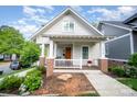 Charming home featuring a welcoming front porch, lovely landscaping and craftsman-style architecture in a desirable neighborhood at 1830 Wickford Pl, Charlotte, NC 28203