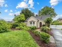 Landscaped front yard and home with lovely curb appeal and white picket fence at 2432 Hassell Pl, Charlotte, NC 28209