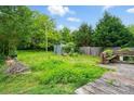 Private backyard with wooden deck, storage shed, and mature trees, perfect for outdoor enjoyment at 2505 Charlotte Hwy, Fort Mill, SC 29707