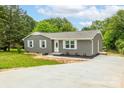 This charming home has a brick facade, manicured lawn and an inviting driveway at 2511 Linwood Rd, Gastonia, NC 28052