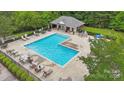 A community swimming pool with lounge chairs and tables for relaxation and socializing at 309 Palm Cove Way, York, SC 29745