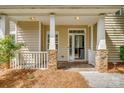Welcoming entrance with stone-accented columns, tiled floor, and a charming porch at 328 Rose Garden Ct, Rock Hill, SC 29732