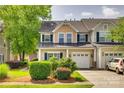 Inviting townhouse featuring well-maintained landscaping, a garage, and neutral siding at 328 Rose Garden Ct, Rock Hill, SC 29732