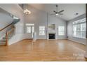 Bright, open living room with hardwood floors, fireplace, and staircase at 328 Rose Garden Ct, Rock Hill, SC 29732
