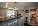 Open living area with bar seating and view into updated bathroom at 407 Orchard Ln, Belmont, NC 28012