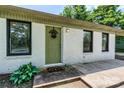 Inviting front entrance with a green door, decorative wreath, and manicured greenery at 413 Picadilly Ln, Troutman, NC 28166