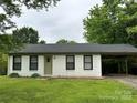 Charming single-story home featuring a carport, freshly painted white brick, and a well-maintained green lawn at 413 Picadilly Ln, Troutman, NC 28166