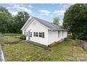 Side view of the house showcasing the white siding and fenced yard at 417 S Broad St, Gastonia, NC 28052