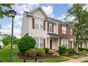 Inviting home exterior with a well-manicured lawn and red brick and siding accents at 4213 Coulter Xing, Charlotte, NC 28213